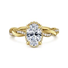 a yellow gold engagement ring with an oval cut diamond in the center and two rows of diamonds on each band