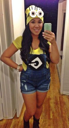 a woman taking a selfie in front of a mirror wearing a costume and holding a cell phone