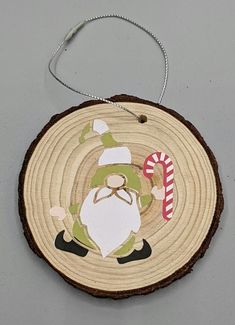 a wooden ornament with a santa clause on it