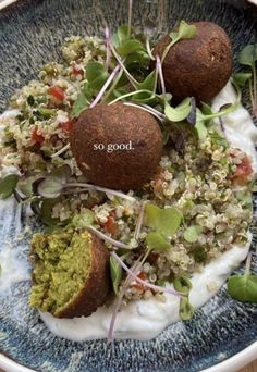 a blue bowl filled with food on top of a wooden table