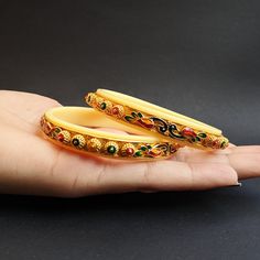 This is a traditional bangle bracelet with Ivory Plastic Ring inside. The design in the bangle is very detailed Meenakari is done according to the details The gold plating is very sustainable You can wear this bangle for any occasion/celebration This bangle goes with every outfit Multicolor Bangle With Intricate Design As Gift, Traditional Bracelets For Marriage, Traditional Multicolor Bracelets For Marriage, Traditional White Bangle For Gift, Traditional White Bracelets For Marriage, Plastic Bangles With Gold Design, Multicolor Bangle With Intricate Design For Gift, Traditional White Bangle For Puja, Multicolor Intricate Design Bangle As Gift