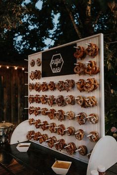 there are many donuts that are on the table and in front of it is a sign