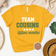 This adorable Team Cousin shirt is perfect for family reunions, gatherings, or just celebrating your bond with your cousins! Made from soft, high-quality material, this shirt is comfortable to wear all day long. Show your cousin love and unity with this stylish and fun design. Available in a variety of sizes and colors, so you can coordinate with your favorite cousins! This shirt makes a great gift to strengthen your family ties. Shop these cool Cousin Shirts today. All shirts are unisex and ava Casual Relaxed Fit Tops For Family Gatherings, Casual Pre-shrunk T-shirt For Family Events, Casual Cotton T-shirt For Family Events, Casual Relaxed Fit Tops For Family Reunion, Pre-shrunk Relaxed Fit Top For Family Reunion, Casual T-shirt With Text Print For Family Reunion, Casual Letter Print Shirt For Family Reunion, Casual Graphic Print Shirt For Family Gatherings, Relaxed Fit Cotton Tops For Family Reunion