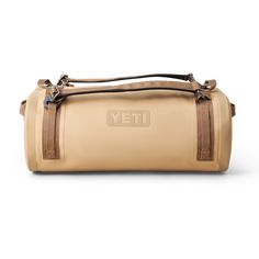 a tan leather duffel bag with the word yet written in large letters on it