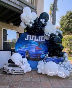 an image of a car with balloons on the ground in front of a house that says jujo