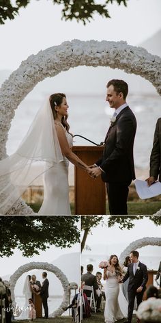 a bride and groom standing at the alter in front of an arch with white flowers