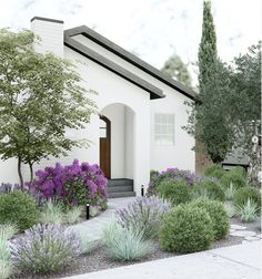 a white house with purple flowers and trees