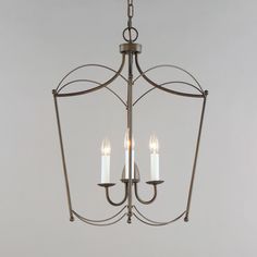 a chandelier with three lit candles hanging from it