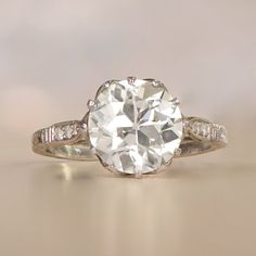 an old - fashioned engagement ring with a round cut diamond