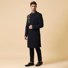 A deep blue indo-western set with embroidery of flowers on chest overlapping panel and sleeve with same fabric pants. Perfect for a groom for pre-events or for a formal party. Delivery Period: 20 Days Formal Bandhgala With Chikankari Embroidery For Festive Season, Formal Sets With Embroidered Sleeves For Eid, Blue Embroidered Unstitched Suit For Formal Occasions, Elegant Straight Kurta Bandhgala For Diwali, Blue Embroidered Unstitched Suit For Formal, Embroidered Blue Unstitched Suit For Formal Occasions, Embroidered Unstitched Suit For Semi-formal Occasions, Formal Blue Embroidered Unstitched Suit, Formal Fitted Sherwani With Embroidered Sleeves