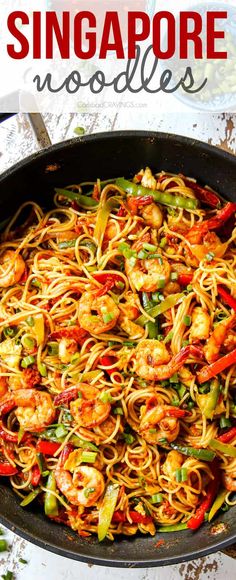 a skillet filled with noodles and shrimp