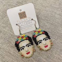 Elegant Frida Kahlo-inspired earrings with colorful Miyuki Beads, crafted by the Wounaan of Colombia and finished with gold plated ear-wires. Channel your inner Frida with these exquisite earrings. Drop length = 2.5in Frida Kahlo Earrings, Miyuki Beads, Earrings Drop, Art Accessories, Ear Wires, Crochet Earrings, Coin Purse, Plating, Beads