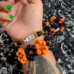 "Handmade Halloween kandi flower cuff beaded bracelets set of 2 spooky accessories beaded jewelry  Halloween boo beaded flower cuff bracelet set  Single bracelet reads \" BOO \"  Black and orange  Perfect for spooky season! Tags; spooky Halloween goth gothic style jewelry accessories beaded bracelets black and orange" Flower Cuff Kandi, Halloween Bracelets With Letter Beads And Round Shape, Halloween Letter Beads Bracelet With Round Beads, Halloween Beaded Bracelets With Letter Beads, Rave Jewelry For Halloween Party, Black Bangle Jewelry With Colorful Beads, Black Bangle With Colorful Beads, Halloween Novelty Beaded Bracelets With Round Beads, Beaded Rave Bracelets For Gifts