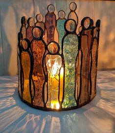 a stained glass candle holder with candles in it