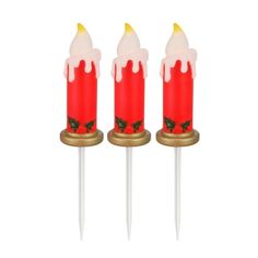 three red candles sitting on top of each other