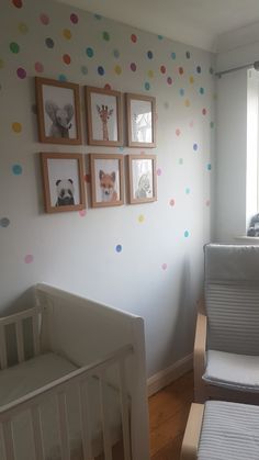 a baby's room with polka dots on the wall