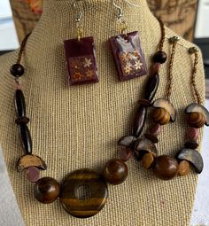 This unique and necklace and bracelet features a beautiful blend of natural wood beads, accented by a stunning tiger's eye centerpiece. The set has earthy tones and organic shapes create a relaxed and free-spirited vibe. Perfect for adding a touch of boho chic to your wardrobe, this necklace is a versatile and eye-catching piece Beaded Necklace And Bracelet, Necklace And Bracelet, Free Spirited, Tiger's Eye, Organic Shapes, Earthy Tones, Free Spirit, Wood Beads, Tiger Eye