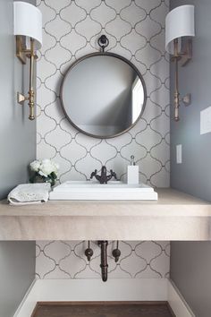 a bathroom sink with a mirror above it and an instagramt to the photo