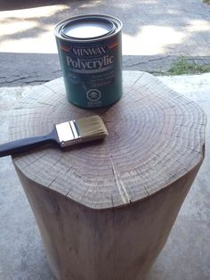 a paint can sitting on top of a tree stump