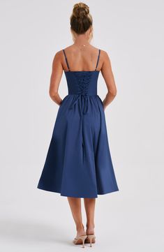 Say hello to dreamy Daisey. the ultra feminine midi dress made in our premium poplin fabric that feels as good as it looks. With an underwired bust and waist cinching. corset bodice. this design has a pretty voluminous skirt and lace up detail to the back.  Colour: Navy. Premium poplin fabric. Underwired bust. Corseted bodice. Voluminous skirt. Lace up back detail. Adjustable straps. Midi length. Model is an XS and is wearing an XS. Midi Dress Elegant, Midi Dress For Women, Backless Midi Dress, Midi Dress Formal, Club Party Dresses, Maxi Dress Sale, Solid Color Dress, Navy Midi Dress, Midi Dress Party