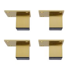 four brass drawer pulls on a white background