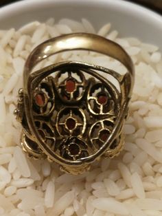 This is the last ring in a set of 5, that I bought in southern Indiana. It's a remarkable Huge 14K ladies Garnet Cluster ring. It weighs a hefty 11.0 grams, and the top measures 24mmx22m. There are 7-6x4mm medium red oval Garnets set with 6 prongs each. There a beaded pattern around each Garnet, and has a scrolled heart design on each side. There are some very fine scratches on a few stones that are considered normal for everyday wear. Its not noticeable unless looking under a 10x loupe. It's a Antique Gold Cluster Ring With Multi-stone, Antique Gold Multi-stone Opal Ring, Antique Gold Opal Ring With Multi-stones, Antique Gold Multi-stone Ring, Antique Gold Ring With Multi-stone, Vintage Gold Multi-stone Cluster Ring, Vintage Gold Multi-stone Ring, Vintage Multi-stone Gold Ring, Antique Oval Multi-stone Ring