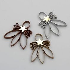 three metal flowers on a white surface