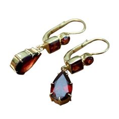 Sensual minimalism. A trio of faceted garnets reflect all the colors of the ballroom. Hand crafted of 24k gold over sterling silver, with European backs for pierced ears. Size: 1 1/4 inches. Gold Garnet Teardrop Earrings, Gold Teardrop Garnet Earrings, Formal Garnet Dangle Earrings, Formal Dangle Garnet Earrings, Elegant Yellow Gold Garnet Earrings, Elegant Gold Garnet Earrings, Formal 14k Gold Faceted Earrings, 14k Gold Faceted Earrings For Formal Occasions, Faceted 14k Gold Earrings For Formal Occasions