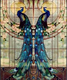 a stained glass window with two peacocks on it