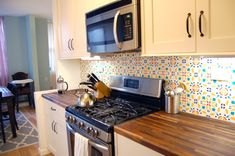 a stove top oven sitting inside of a kitchen next to a microwave above a counter