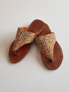 Maasai sandals made with high quality leather and colorful fine beads. Perfect for outdoor summer events , beach wear , festivals , African themed events etc. Buy multiple items and pay shipping for one item Only. Back to my shop; https://www.etsy.com/shop/TribalTess?ref=seller-platform-mcnav Multicolor Leather Flip Flops For Vacation, Multicolor Beaded Barefoot Sandals For Vacation, Multicolor Beaded Sandals For Festival, Multicolor Beaded Flip Flops For Festival, Beaded Multicolor Flip Flops For Festivals, Beaded Multicolor Flip Flops For Summer, Traditional Multicolor Beaded Flip Flops, Multicolor Toe Ring Sandals For Beach, Multicolor Beaded Leather Flip Flops