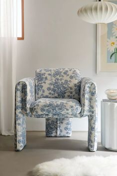 a blue and white chair sitting in front of a window