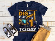 a t - shirt that says dig and play i'm 1 today with an excavator on it