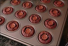 chocolate cupcakes in a muffin tin ready to be baked into the oven