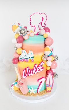 there is a cake decorated with different things on it's side and the words violet written in large letters