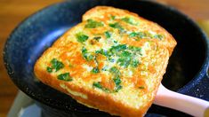 an omelet is being cooked in a skillet