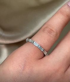 a woman's hand with a diamond ring on it