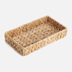 a woven rectangular tray on a white background