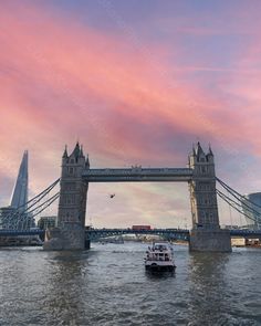 a boat is going under the tower bridge