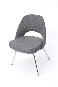 a grey chair with metal legs on a white background