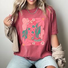 Unleash your free-spirited cowgirl vibes in our Boho Cowgirl T-Shirt. With a touch of boho style, this abstract floral design adds a playful twist to your wardrobe. Perfect for expressing your unique, fun-loving personality. Spring Festival Casual T-shirt, Bohemian Spring T-shirt With Graphic Print, Free-spirited Crew Neck Tops For Spring, Spring Free-spirited Crew Neck Top, Spring Bohemian T-shirt With Graphic Print, Casual T-shirt For Spring Festival, Casual Spring Festival T-shirt, Bohemian Printed T-shirt For Spring, Summer Free-spirited Tops With Graphic Print