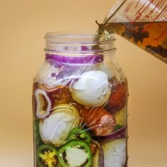 a jar filled with lots of different types of vegetables