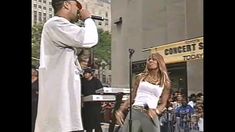 a man standing next to a woman on top of a stage in front of a crowd