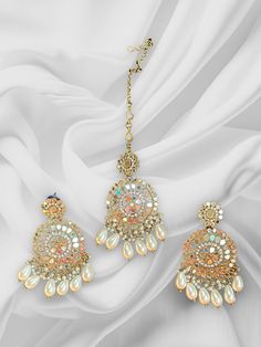 High Quality Silver and Pearl White finish with beaded work, this set is sure to be a perfect addition to any wardrobe! This mirror work tikka set is perfect for any bridesmaid, bride, sangeet or any occasion or event as a gift for any occasion as any one who loves jewelry will love this statement piece. It has beautiful colors that really make the set a statement piece. Product Details: • Maang tikka • Earrings Free Shipping/Ready to Ship and available immediately if you place an order today! F Wedding Sets With Gota Work Chandbali Style, Wedding Sets With Stone Work In Multicolor, Multicolor Wedding Sets With Stone Work, Multicolor Wedding Set With Stone Work, Eid Celebration Stone Work Tikka, Chandbali Kundan Tikka With Mirror Work, Chandbali Jhumkas With Dori Work For Wedding, Kundan Bridal Sets For Wedding And Eid, Wedding Chandbali Jhumkas With Dori Work