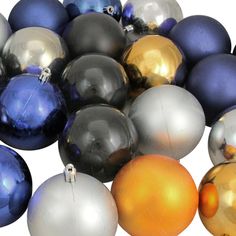 a pile of shiny silver and blue christmas ornament baubles on white background