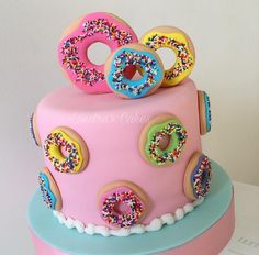 a cake with donuts and sprinkles on top