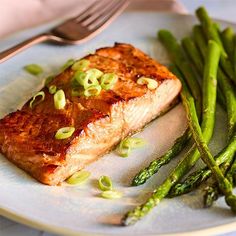 a piece of salmon and asparagus on a plate