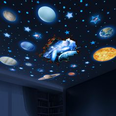 a room with planets and stars on the ceiling