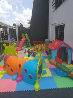 children's play area with various toys on the floor and inflatable mats