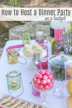 a table topped with lots of cupcakes and cake